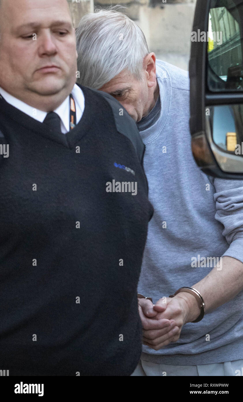Geoffrey Crossland (right) is lead away in handcuffs to a prison van after being jailed for more than 12 years at York Crown Court, he amassed one of the largest known hauls of indecent images in England and Wales. Stock Photo