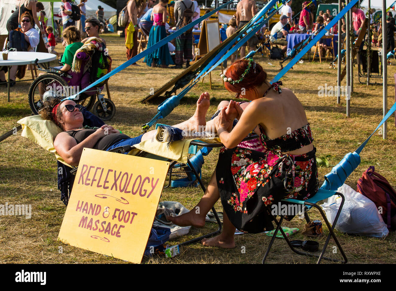 Mobile reflexology, hand and foot massage at Into the Wild festival, Kent, UK Stock Photo