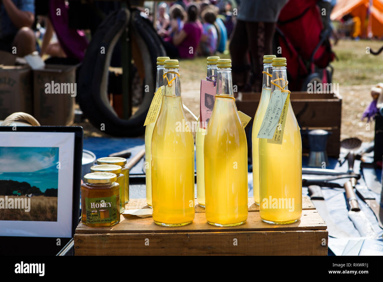 Home pressed apple juice for sale at a stall at Into the Wild festival, Kent, UK Stock Photo