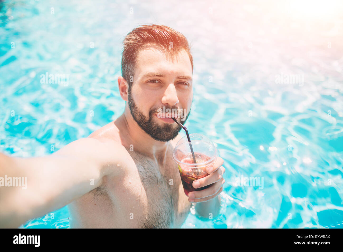 https://c8.alamy.com/comp/RXWRAX/happy-bearded-man-making-selfie-in-swimming-pool-he-is-drinking-a-cocktail-and-relaxing-RXWRAX.jpg