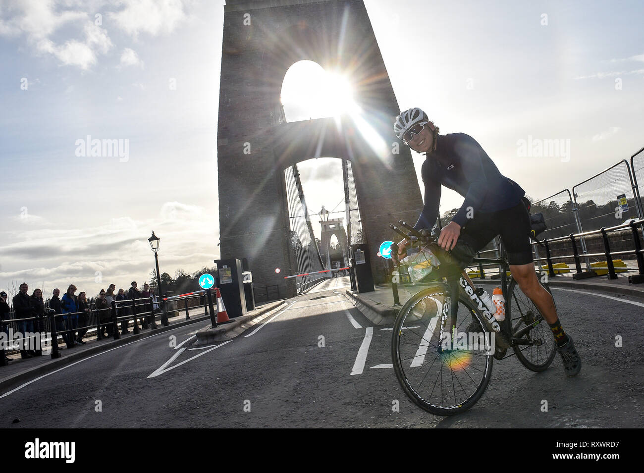 18 year old Charlie Condell crosses over the Clifton Suspension Bridge to arrive back in Bristol after completing a 18,000 miles (30,000km) adventure and claims to be the youngest Briton to travel around the world solo and unassisted on a bicycle. Stock Photo