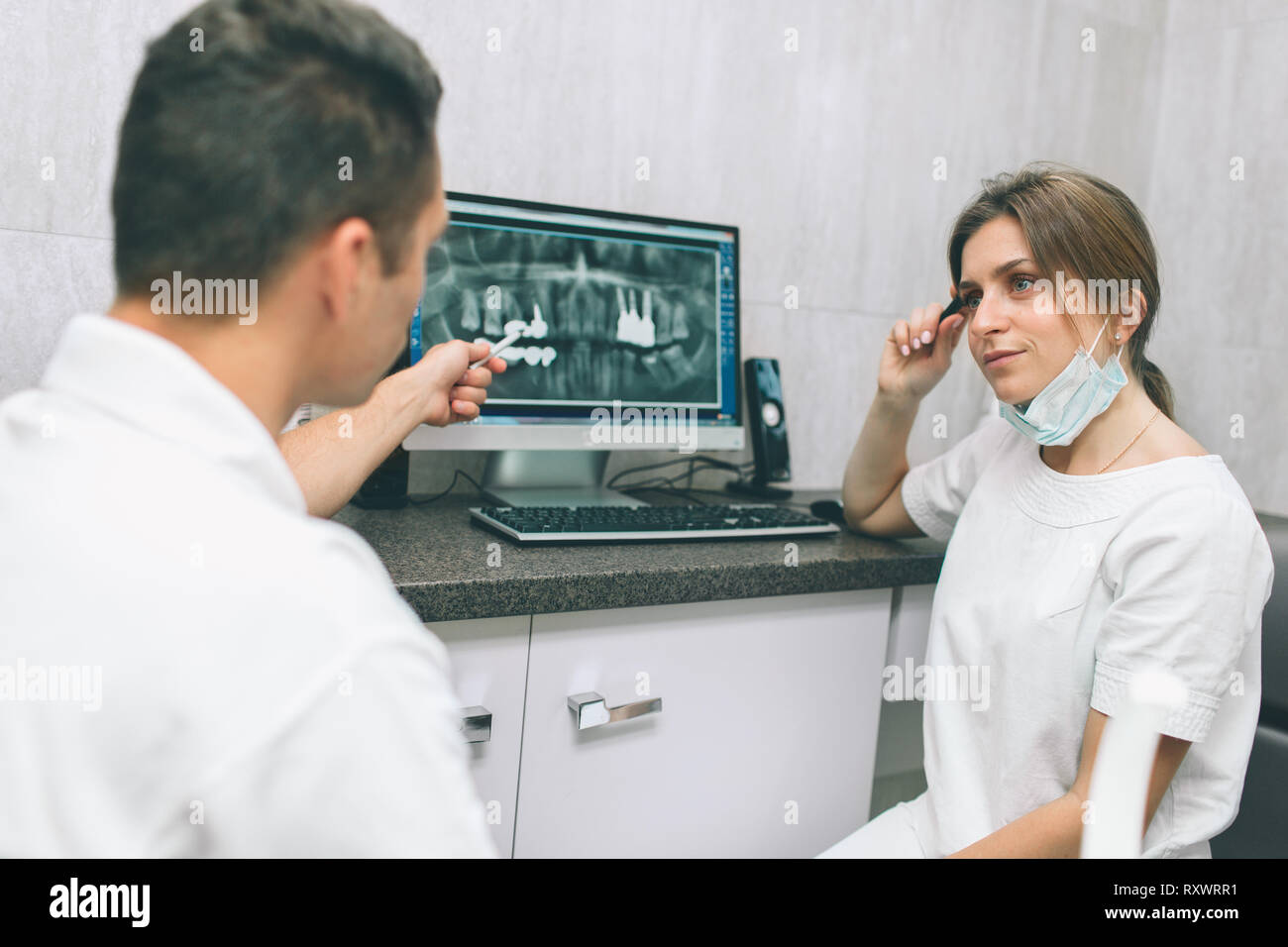 Two concentrated dentists looking at x-ray on computer Stock Photo