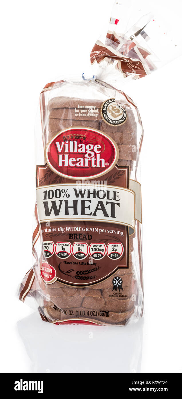 Winneconne, WI - 3 March 2019: A package of Village Hearth whole wheat loaf bread on an isolated background Stock Photo
