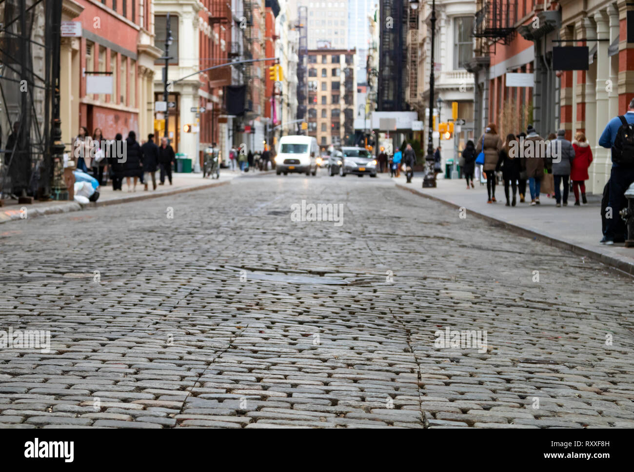 View of cobblestone covered Greene Street with bright sunlight
