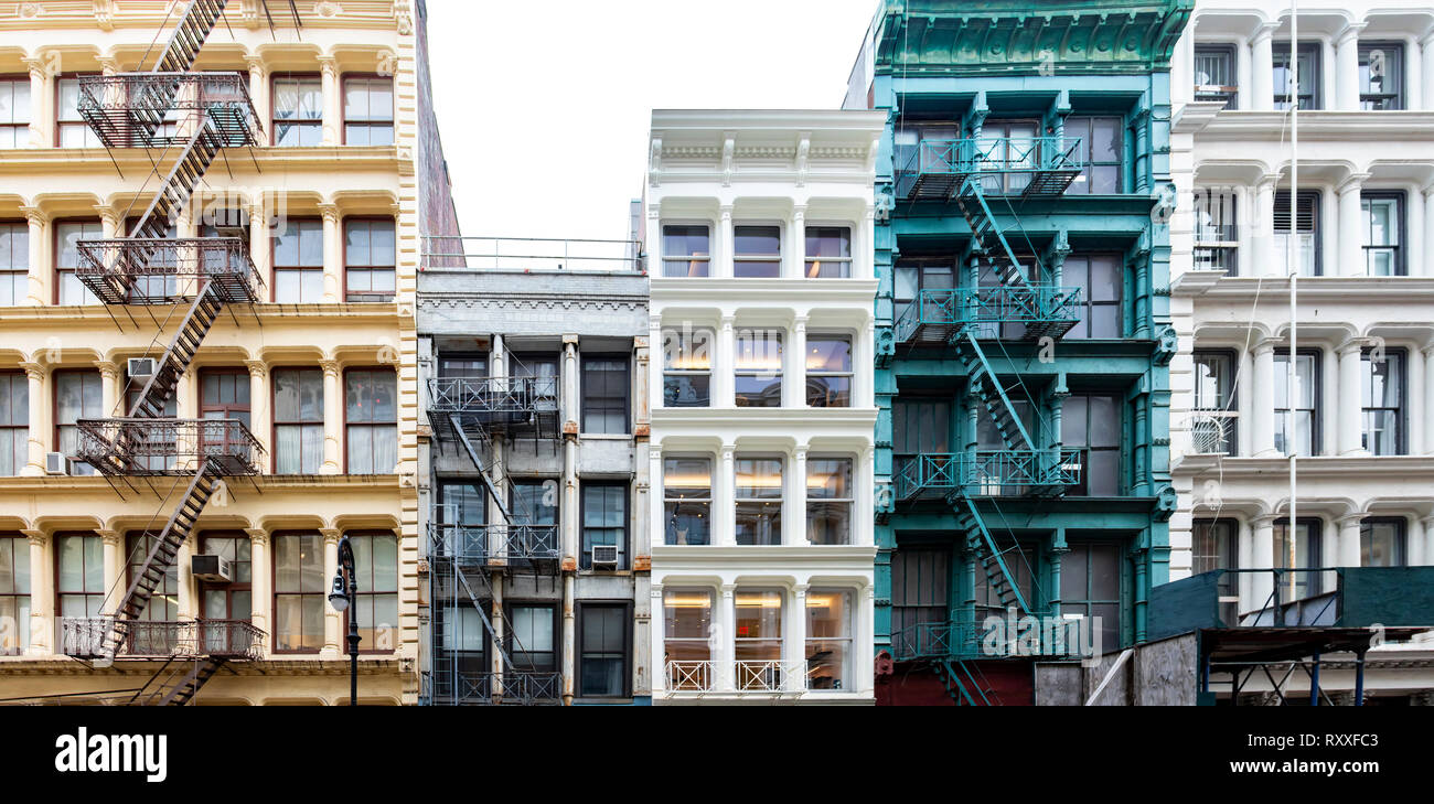 Exterior view of a block of colorful old historic buildings along Greene Street in the SoHo neighborhood in Manhattan, New York City with pattern of w Stock Photo