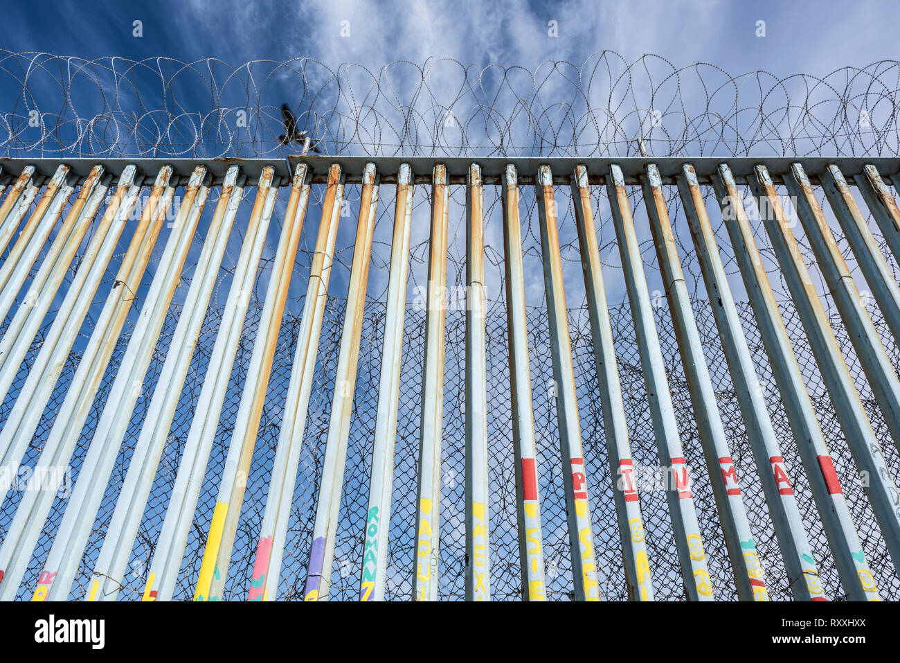 A bird flying over the borderline at Tijuana, San Diego. Stock Photo