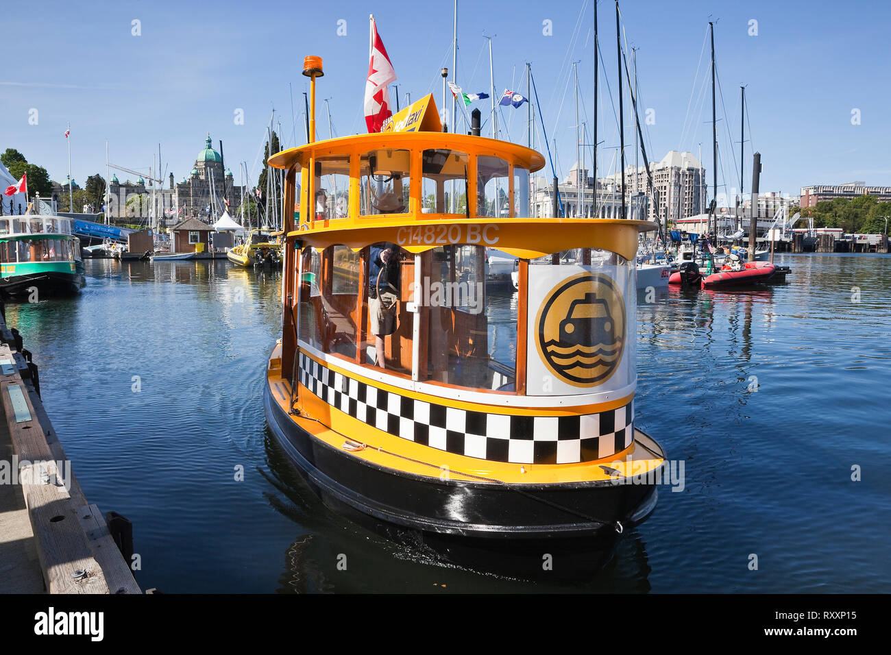Borrowing from the style of New York City's iconic cabs, H2O Taxi is operated by the Victoria Harbour Ferry company and ferries passengers to a dozen stops in Victoria's Inner Harbour, Victoria, British Columbia, Canada Stock Photo