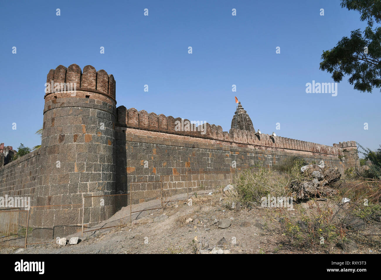 Stone masonry wall with Cylindrical watch towers at intervals surrounding entire village of  Vitthal Temple, Palashi, Parner, Ahmednagar. Stock Photo