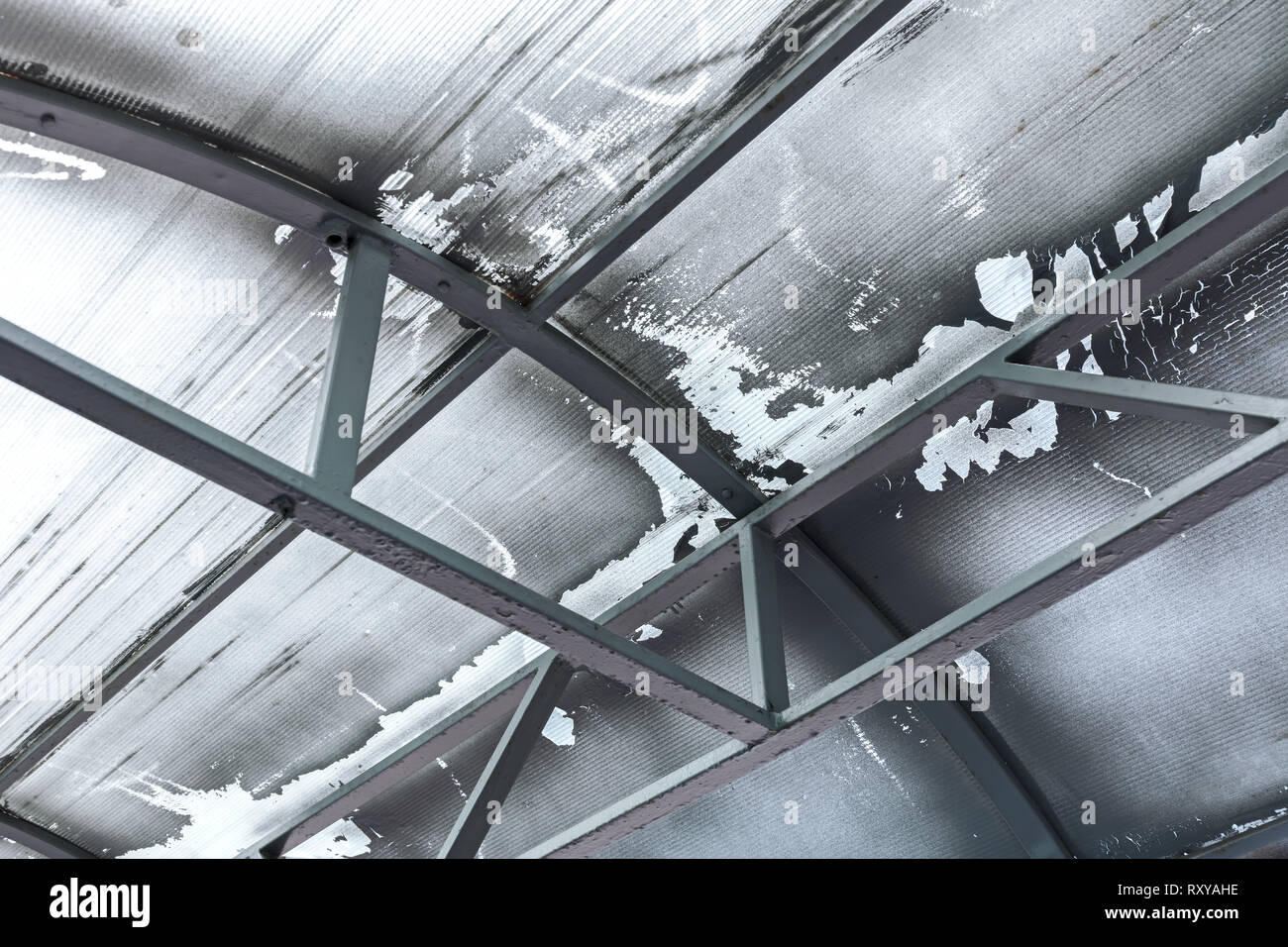 storehouse weathered old ceiling with metal beams, closeup bottom view Stock Photo