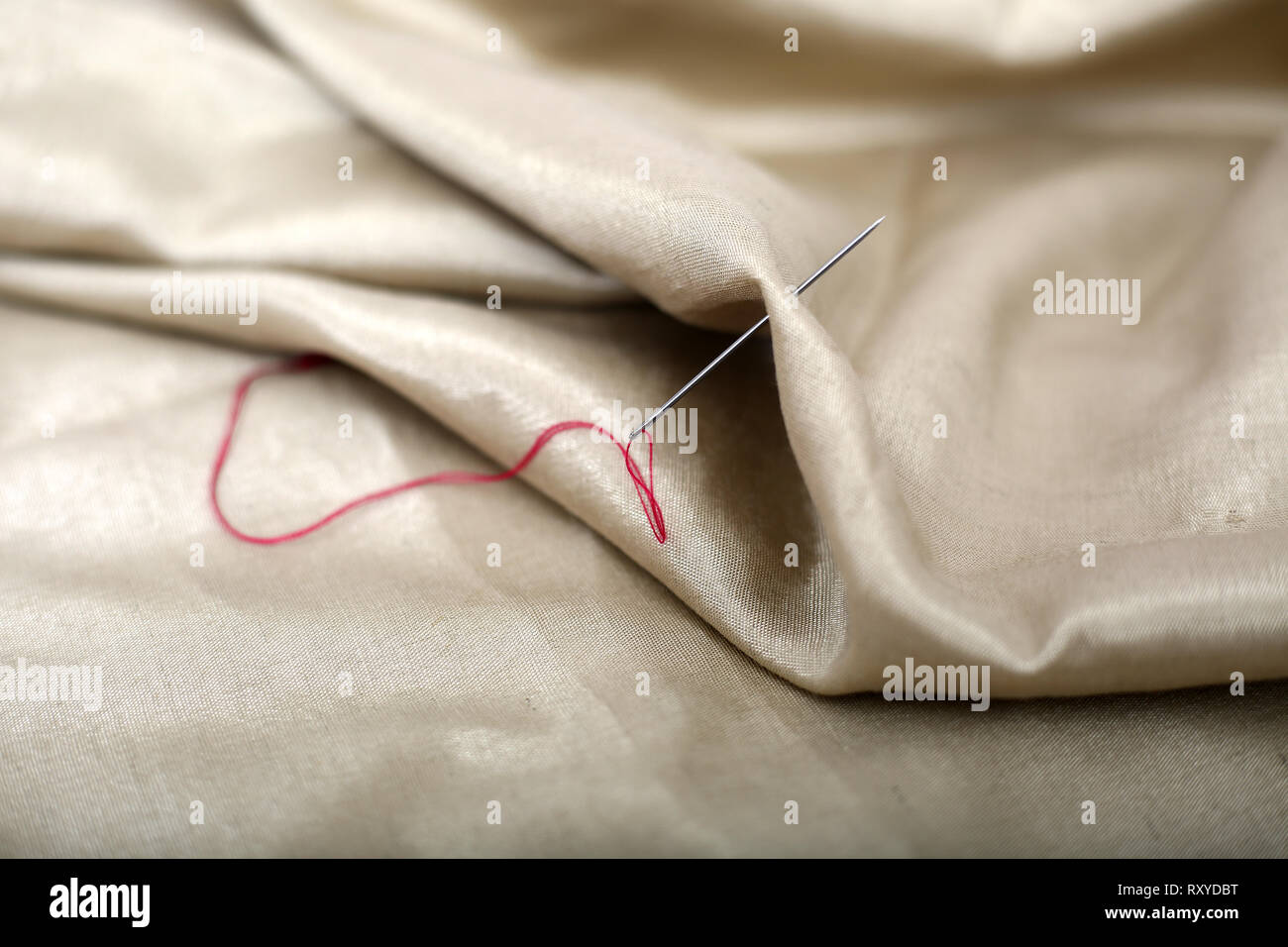 Picture of thread and needle attached in cloth Stock Photo Alamy
