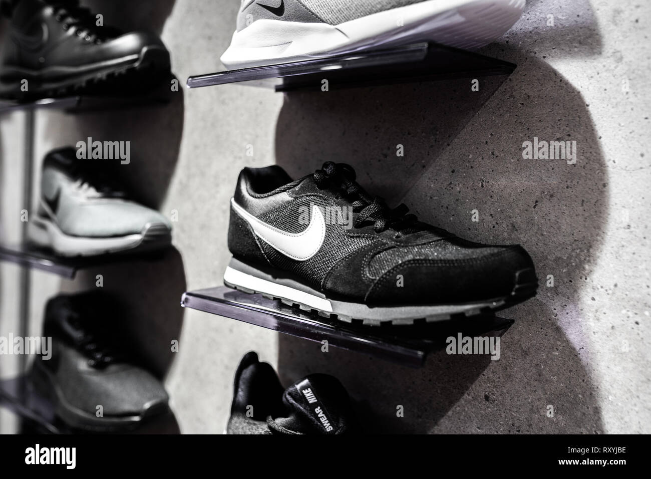 Nurmberg, GERMANY - February 27, 2019: The NIKE black man sneakers on the shell in the shop. Fashionable foot wear shoes. Close up photo sport concept Stock Photo