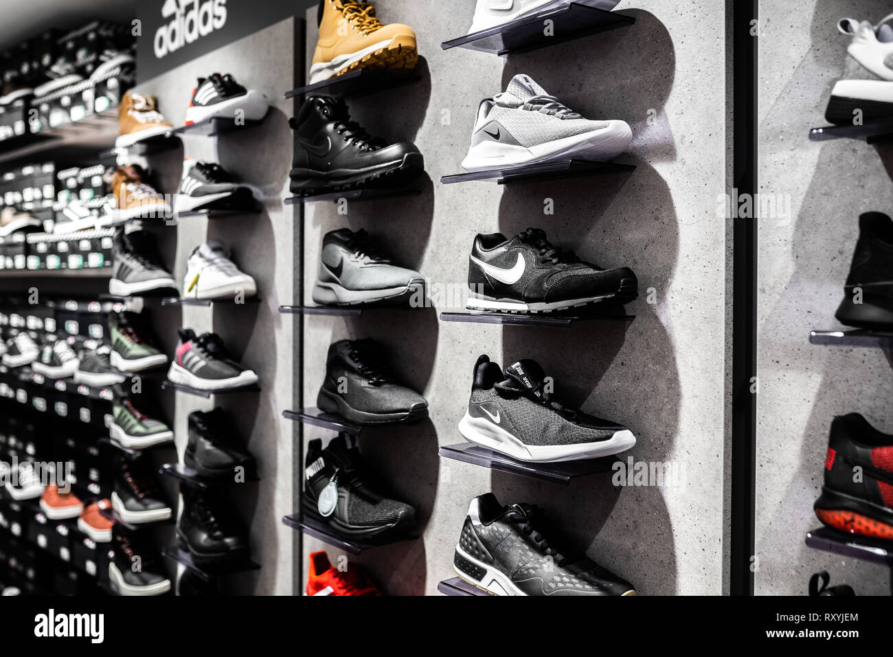 Nurmberg, GERMANY - February 27, 2019: The NIKE black man sneakers on the shell in the shop. Fashionable foot wear shoes. Stock Photo