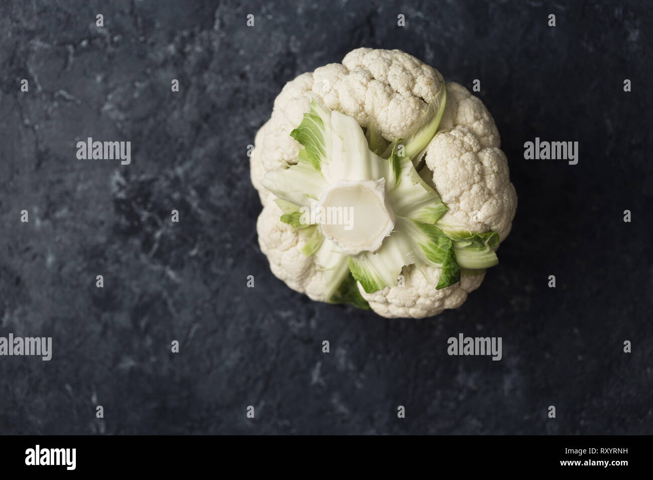 Fresh cauliflower head on dark background with copy space top view Stock Photo