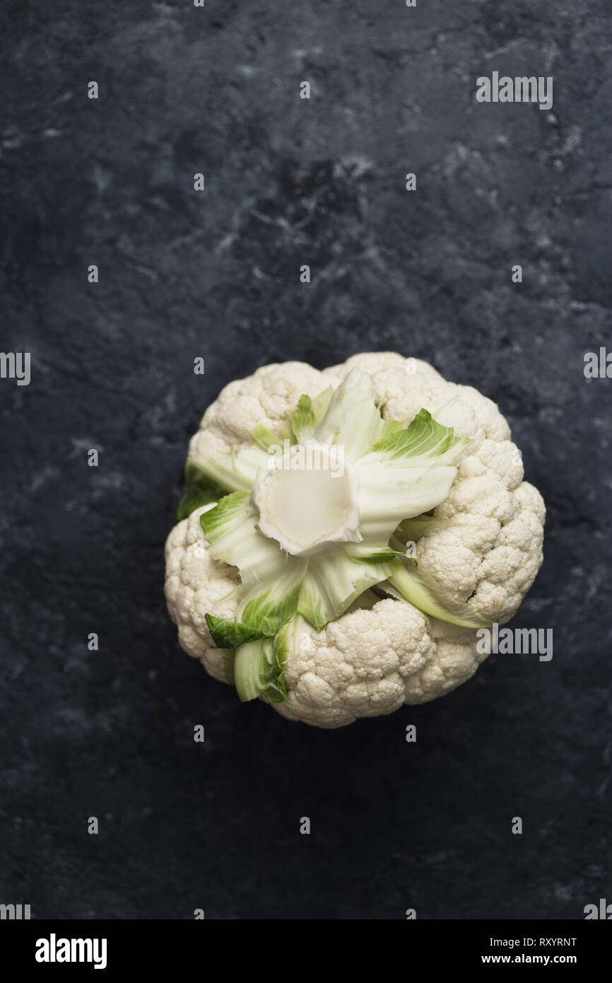 Fresh cauliflower head on dark background top view Stock Photo