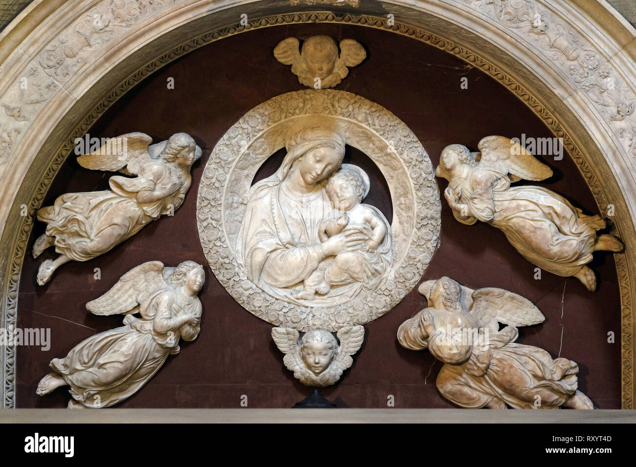 Madonna with four angels, Tomb of Filippo Strozzi, marble, by Benedetto da Majano, Santa Maria Novella Principal Dominican church in Florence, Italy Stock Photo