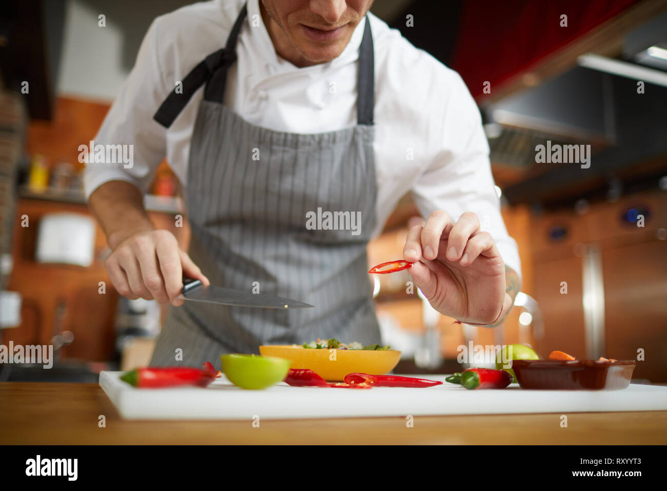 Unrecognizable Chef Cutting Vegetables Stock Photo