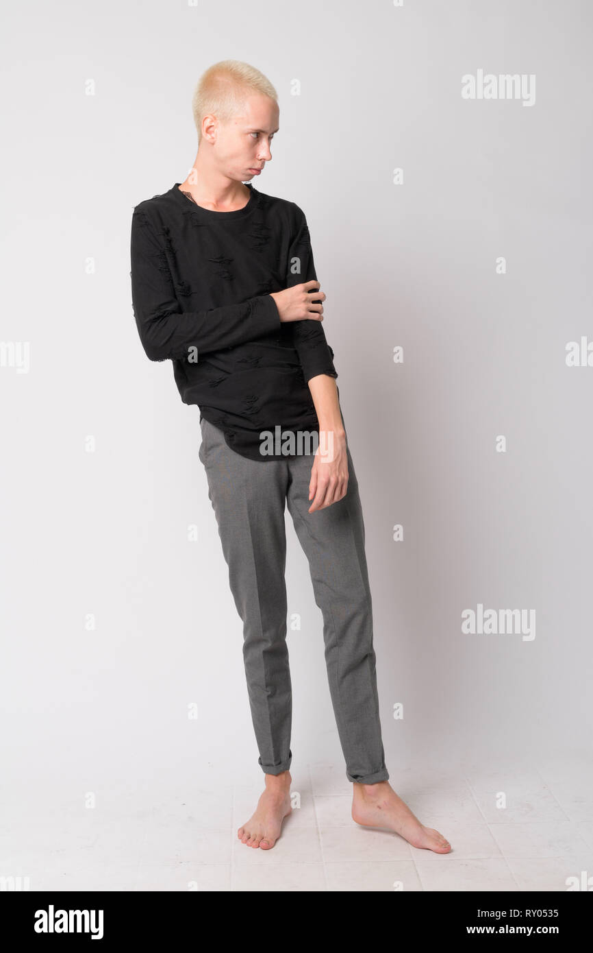 Full body shot of young handsome androgynous man thinking Stock Photo ...