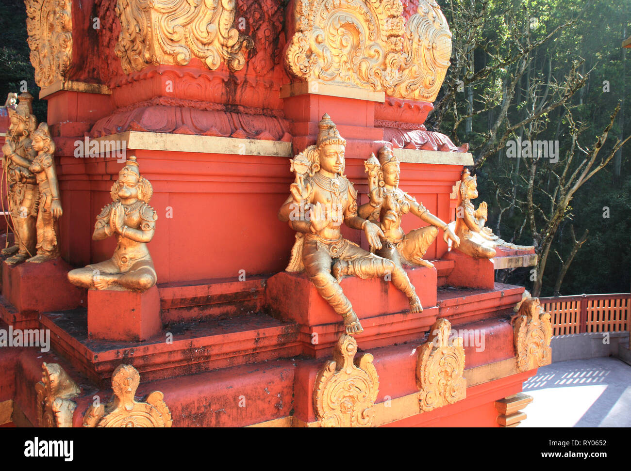 Gilded statues of the Hindu deities, heroes of Ramayana and Lord Hanuman on red vimana tower, Seetha Amman Temple, Seetha Eliya village, Nuwara Eliya, Stock Photo