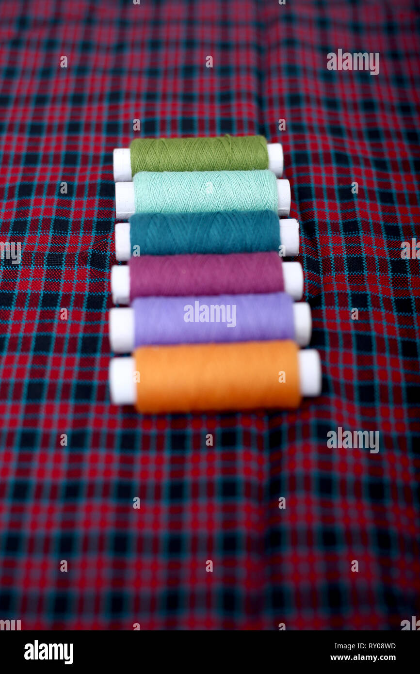 Picture of colored sewing thread on the cloth Stock Photo - Alamy