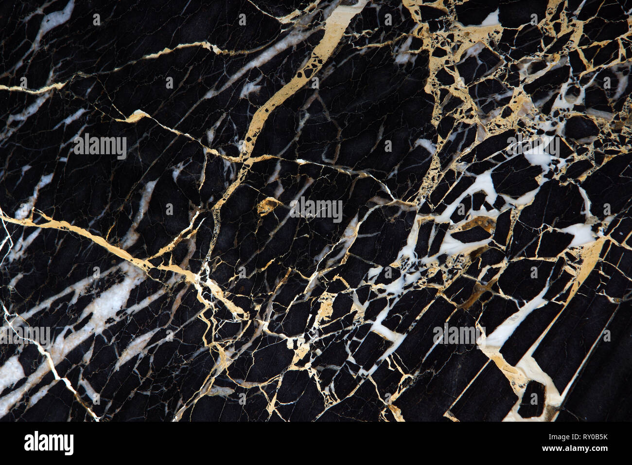 A slab of black expensive marble with yellow streaks is called New ...