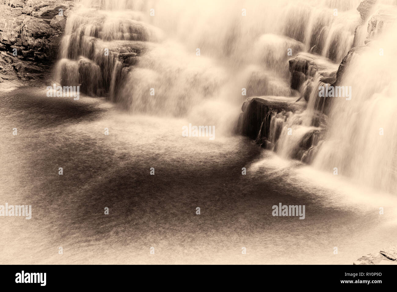 Corra Linn Falls at the Falls of Clyde New Lanark. An image of New Lanark with the lower falls in spate. Use of  a 10 times Neutral Density Filter. Stock Photo