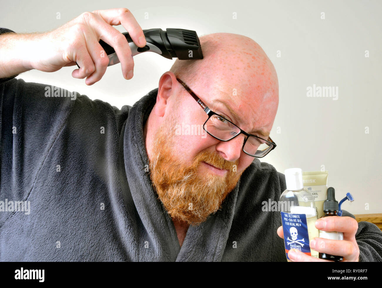 Bald man shaving Stock Photo