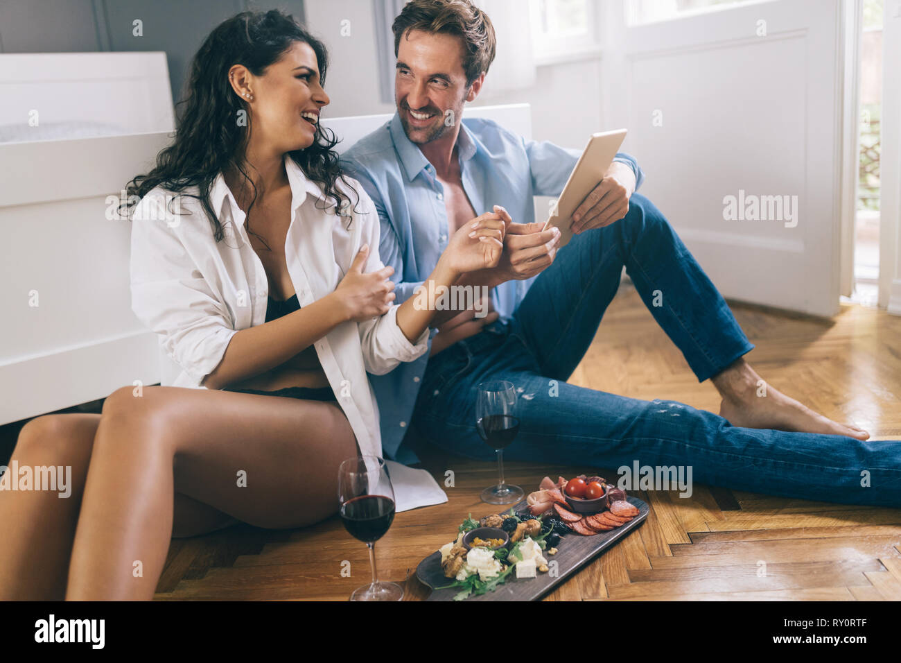 Portrait of happy couple shopping online using digital tablet Stock Photo