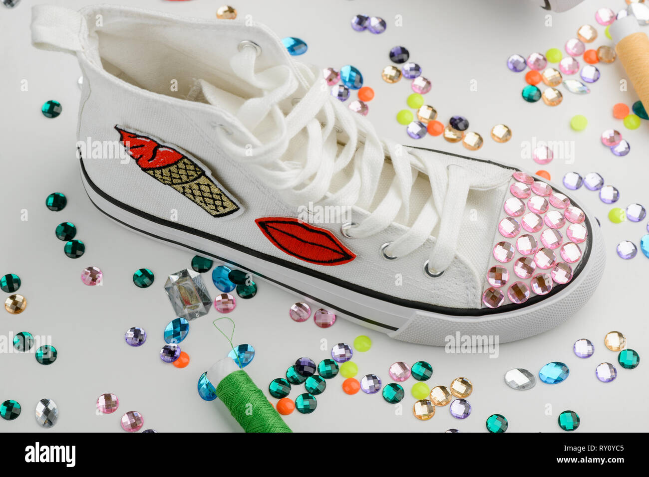 White sneaker decorated with rhinestones Stock Photo Alamy