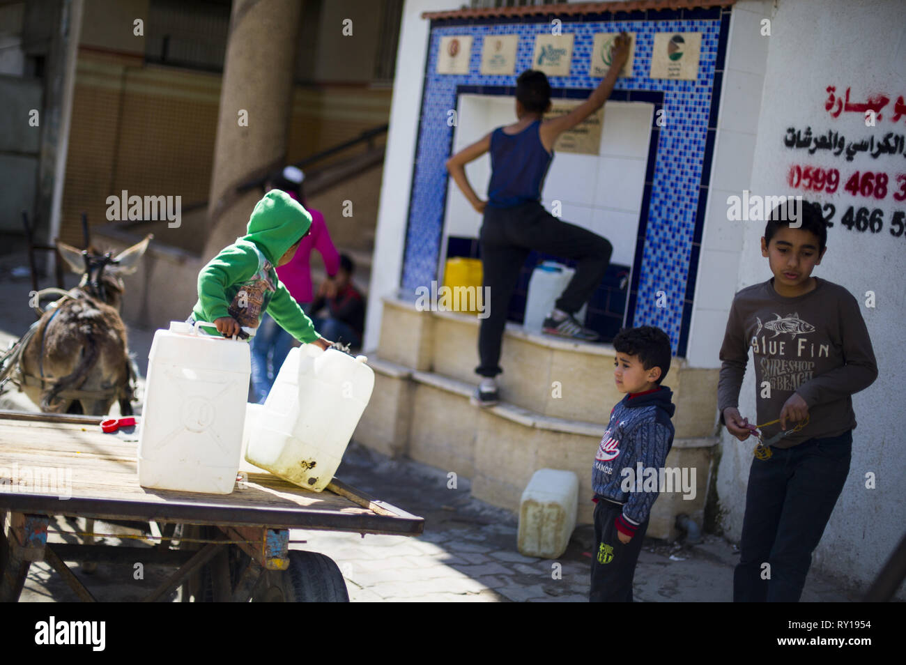 Gaza City, The Gaza Strip, Palestine. 11th Mar, 2019. Palestinian children are seen fetching water at the Bureij refugee camp, south of the Gaza Strip.More and more Gazans are falling ill from their drinking water, highlighting the humanitarian issues facing the Palestinian enclave that the UN says could become uninhabitable by 2020. Credit: Mahmoud Issa/SOPA Images/ZUMA Wire/Alamy Live News Stock Photo