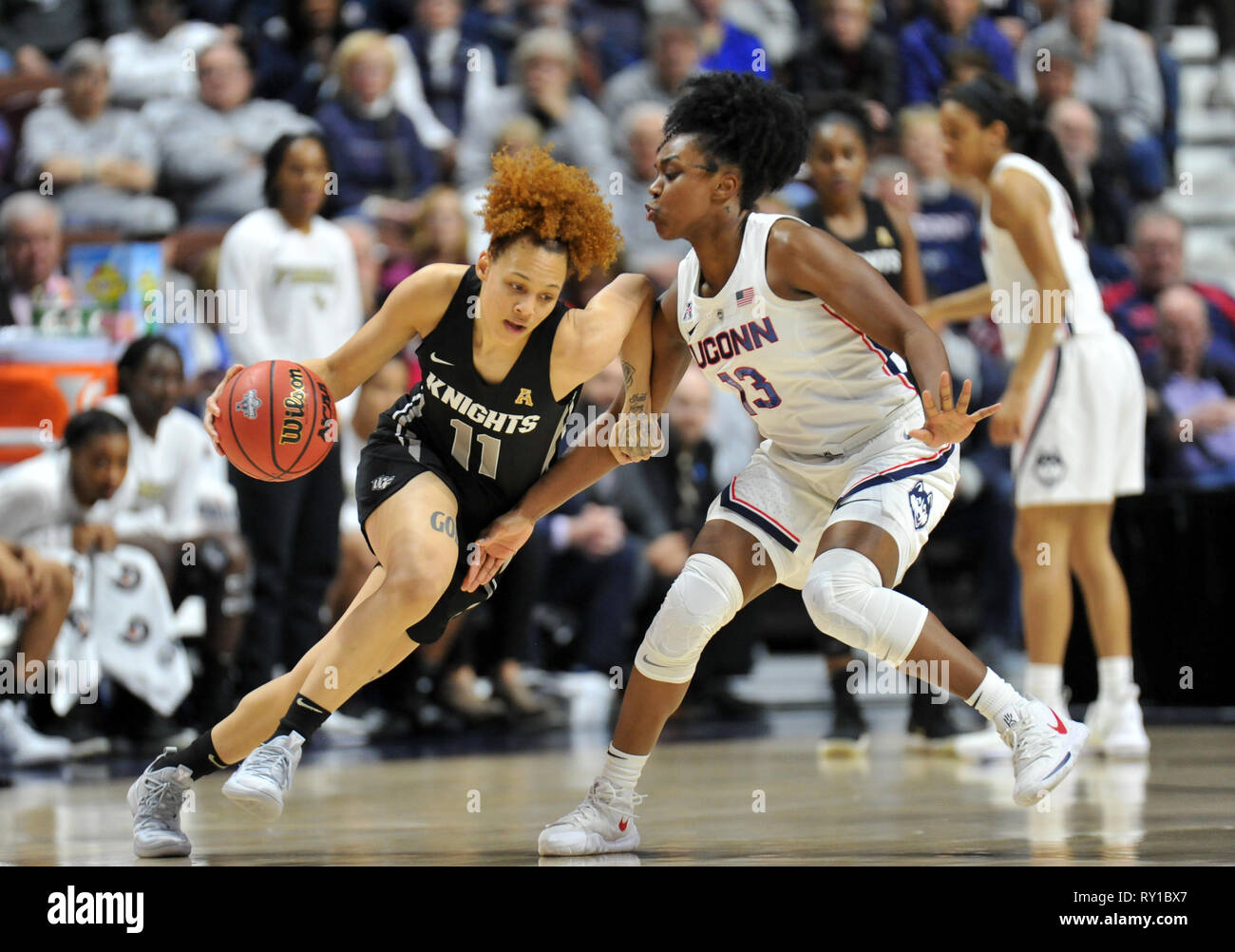 Uncasville, CT, USA. 11th Mar, 2019. Kayla Thigpen (11) of the UCF Knights tries to get past Uconn defender Christyn Williams (13) during the NCAA American Conference Basketball Tournament Championship game at Mohegan Sun Arena in Uncasville, CT. Gregory Vasil/CSM/Alamy Live News Stock Photo