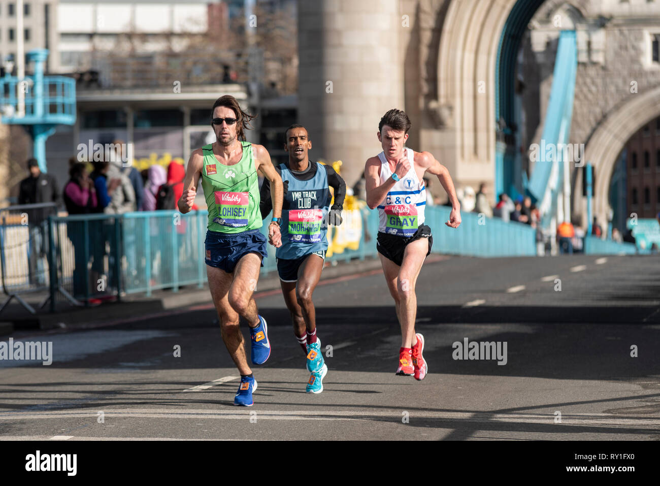 Mick Clohisey, Mustafa Mohamed, Jack Gray running in the Vitality Big Half half marathon crossing Tower Bridge, London, UK. Stock Photo