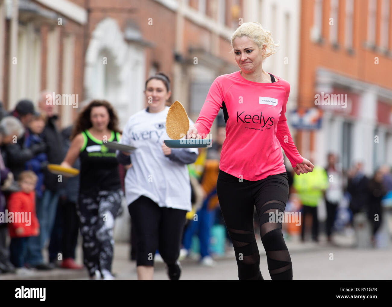 The annual Shrove Tuesday pancake race taking place in Bore Street, Lichfield, England, UK Stock Photo