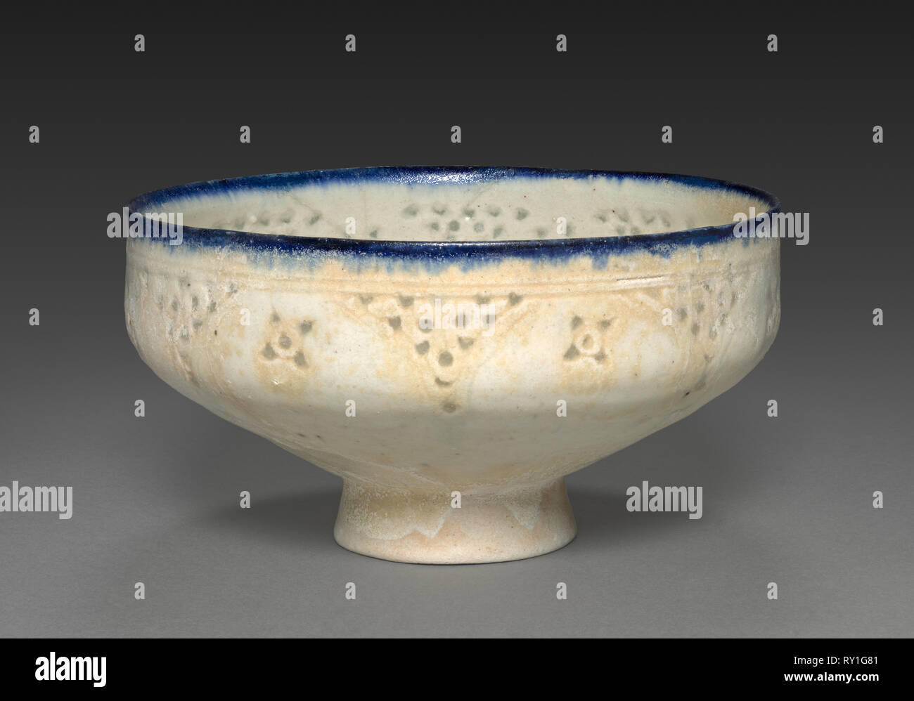 Footed Bowl, late 1100s-early 1200s. Iran, probably Kashan, Seljuq period, late 12-early 13th century. Fritware, pierced and underglaze painting; overall: 9.8 x 18.2 cm (3 7/8 x 7 3/16 in Stock Photo