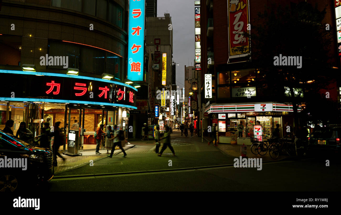 Tokyo, Japan - October 15 2018 : Neon signs and shop windows brightly light this night shot of downtown Tokyo in Japan. Stock Photo
