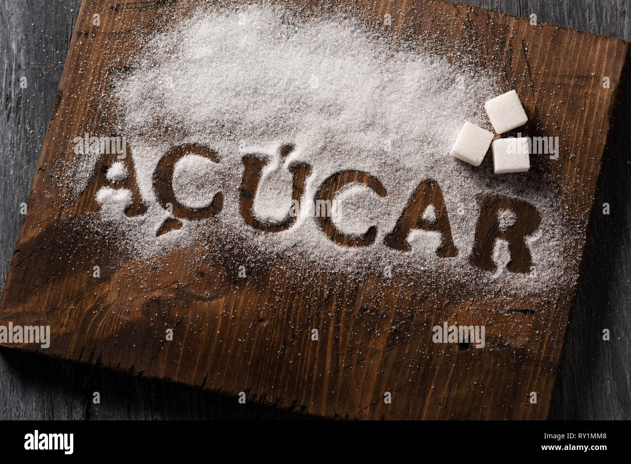 high angle view of a wooden chopping board sprinkled with sugar where ...