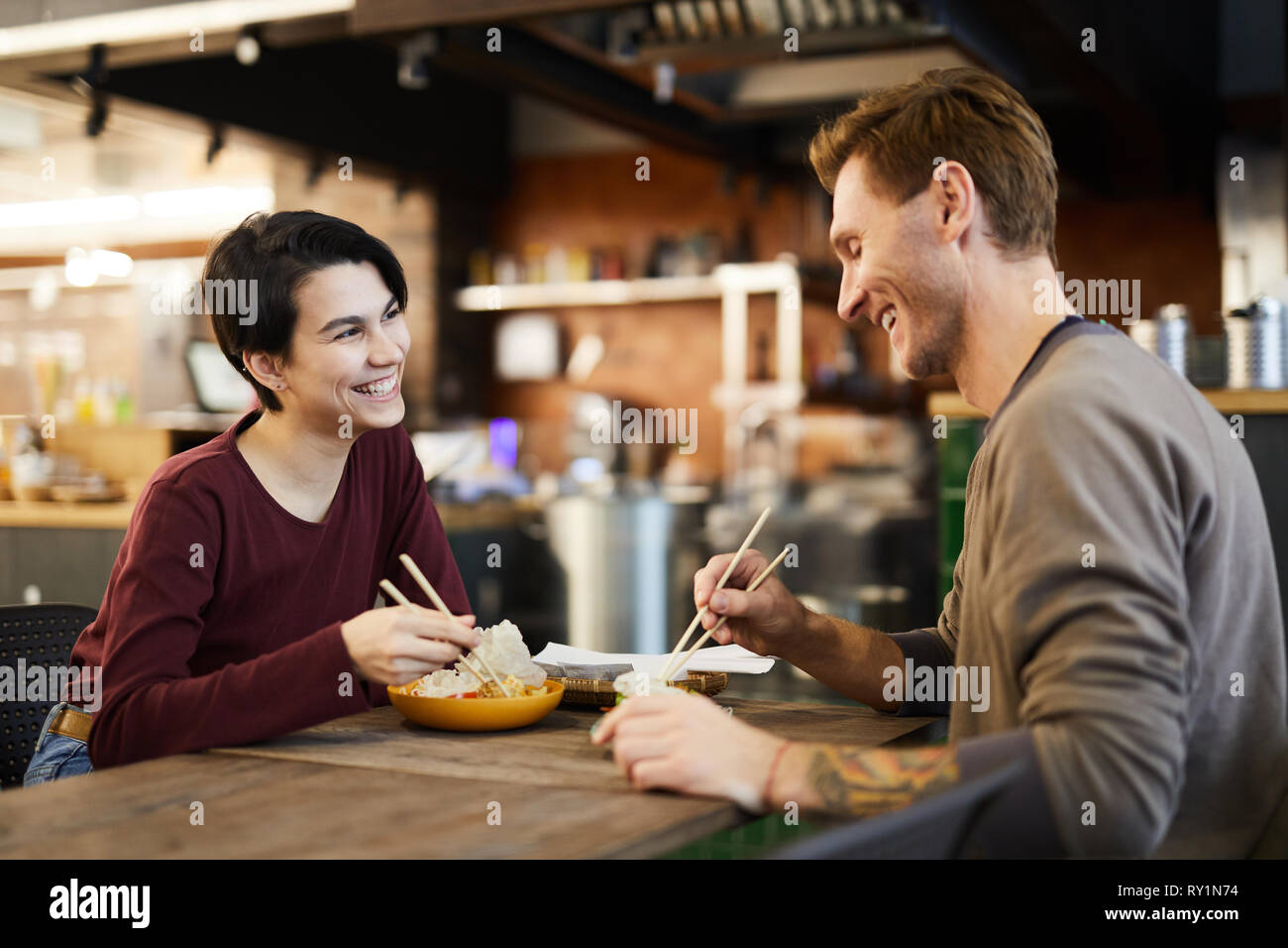 Cheerful Couple in Chinese Food Restaurant Stock Photo