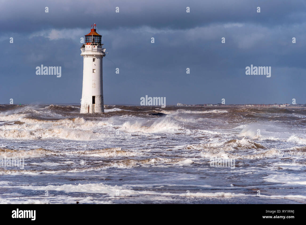 Perch Rock lighthouse New Brighton on a stormy wetaher day with waves. Stock Photo