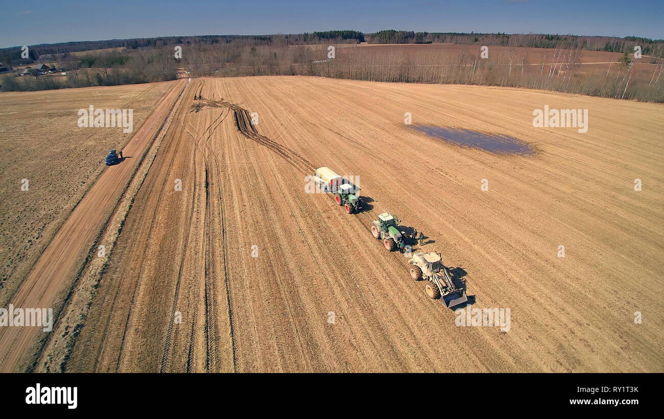 Aerial view of the big field with brown crops and the tire traces on the field from the trucks Stock Photo