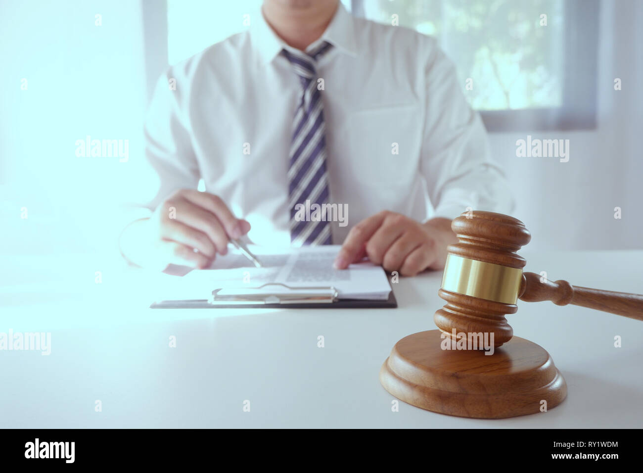 Legal counsel presents a contract with gavel and legal law. justice and lawyer concept Stock Photo