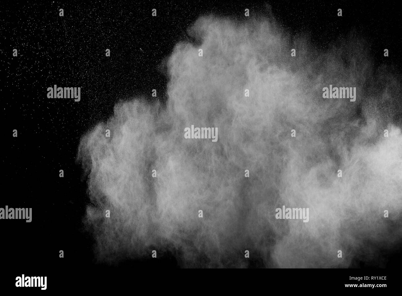 White powder explosion isolated on black background. White dust ...