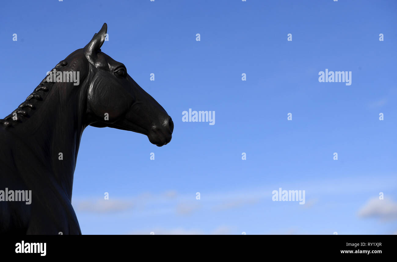 The statue of Arkle overlooks the parade ring during a preview day ahead of the 2019 Cheltenham Festival meeting. Stock Photo