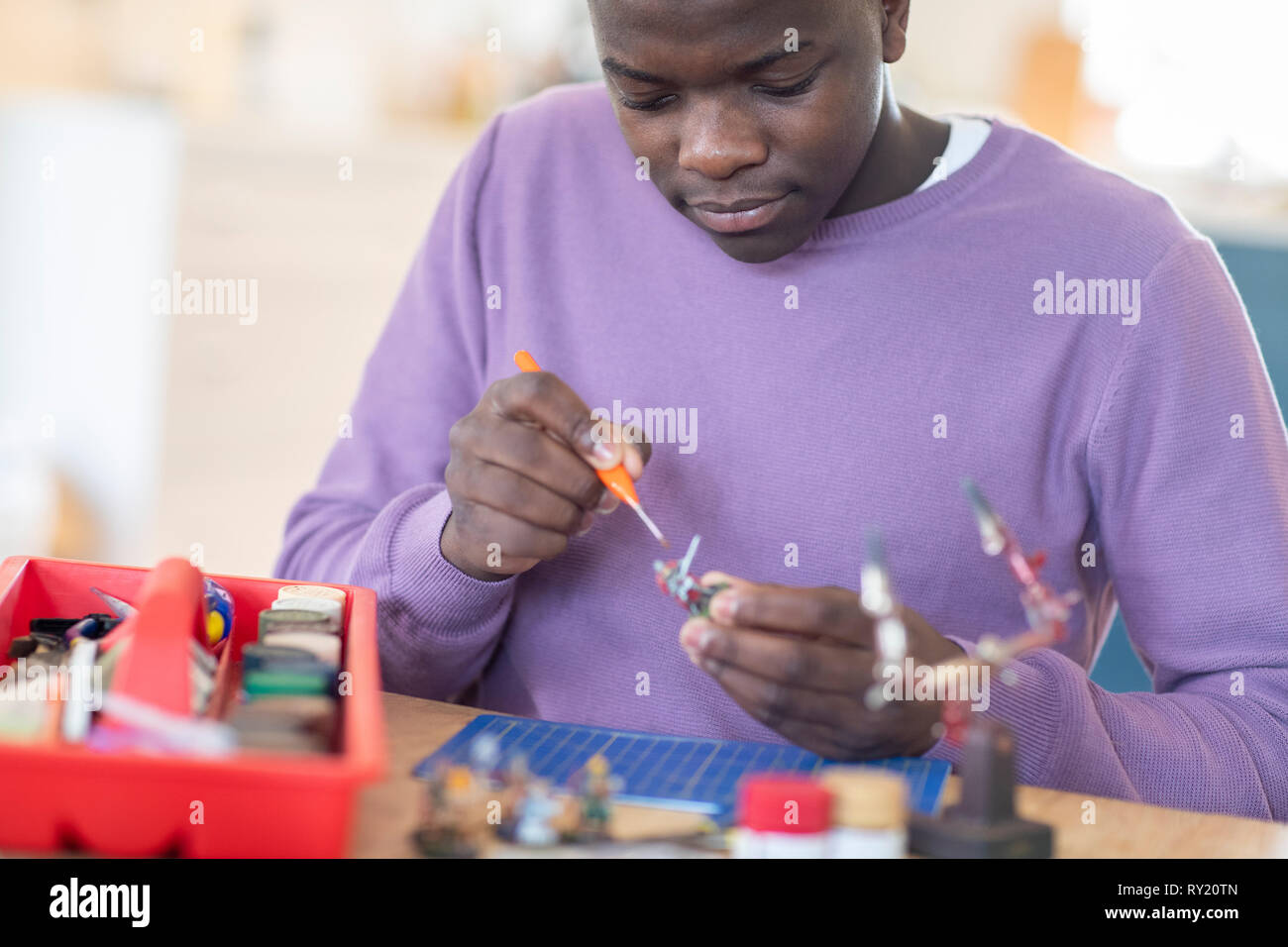 Teenage Boy Painting War Game Model Figures At Home Stock Photo Alamy