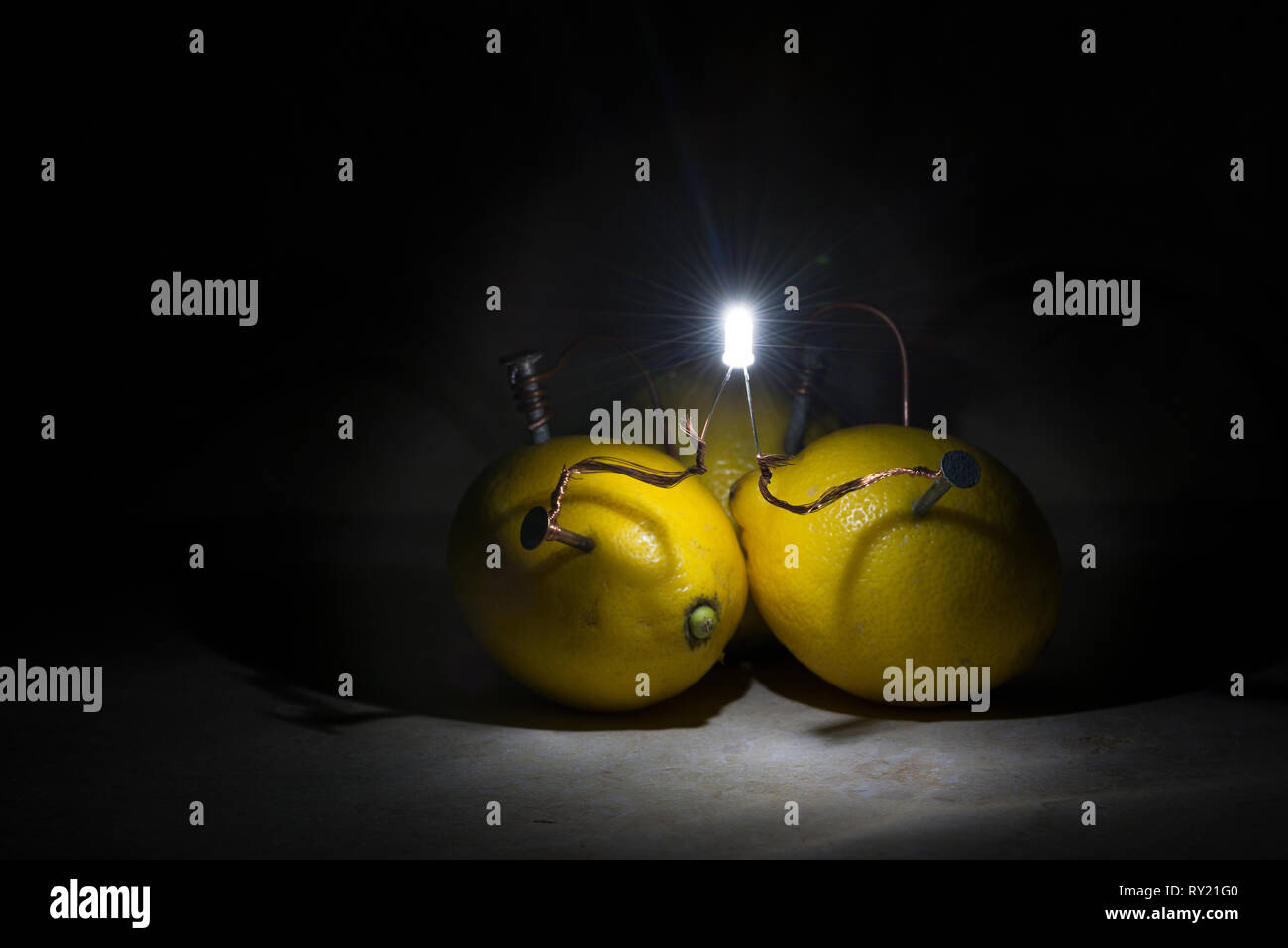 Citrus fruit, lemon, lime, tangerine demonstrating an alternative organic source of electricity as powerhouse battery cells lighting led light Stock Photo