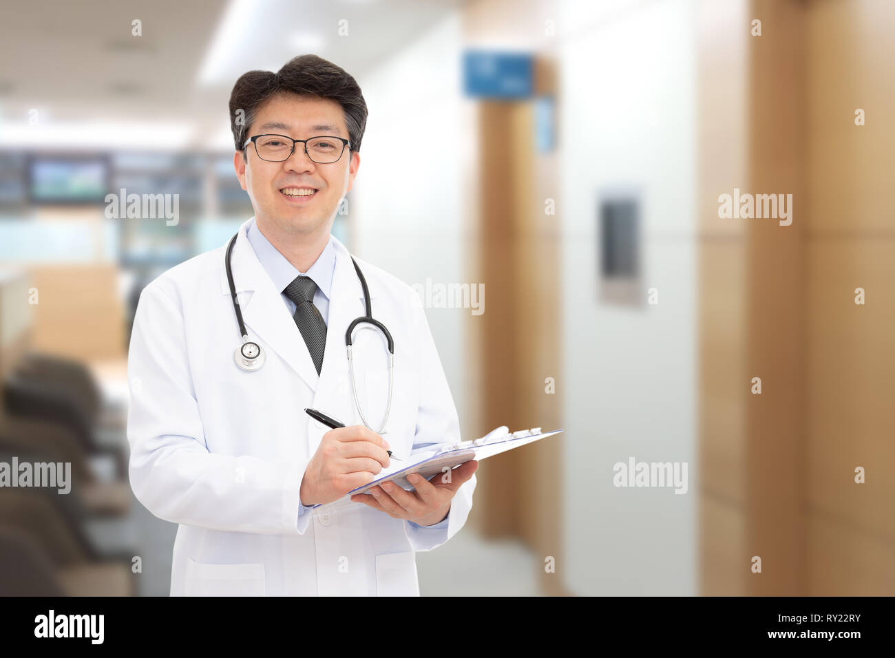 Asian male doctor smiling in the background of the hospital. Stock Photo