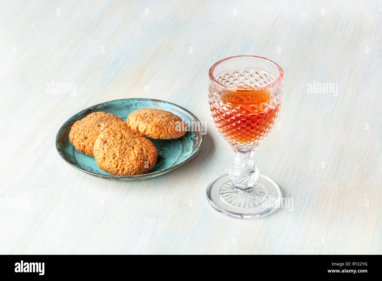 A photo of a glass of sweet wine with cookies and a place for text Stock Photo
