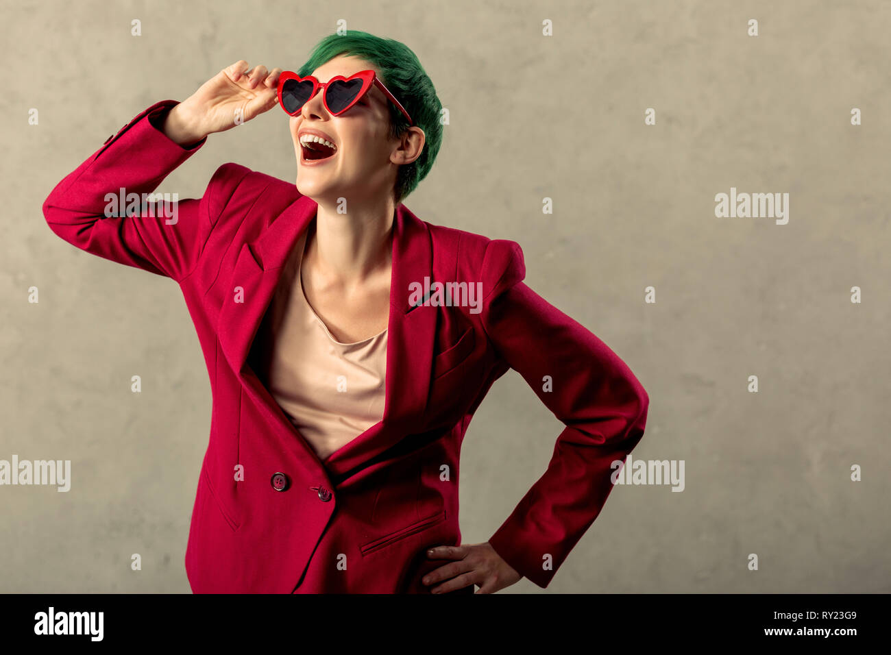 Young woman touching sunglasses hi-res stock photography and images - Alamy