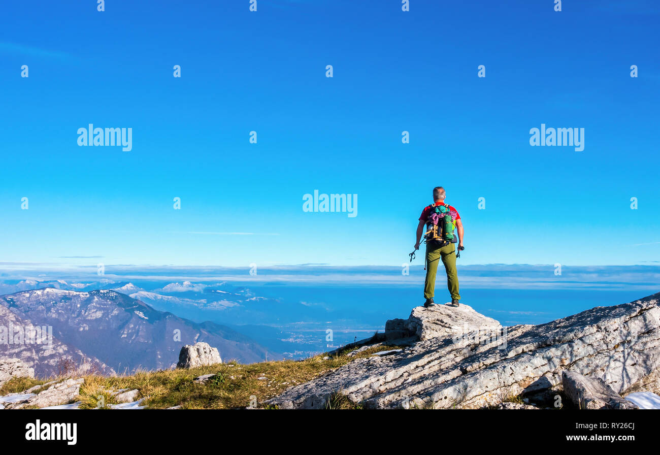 Hiker on the top in mountains. Travel sport lifestyle concept. Stock Photo