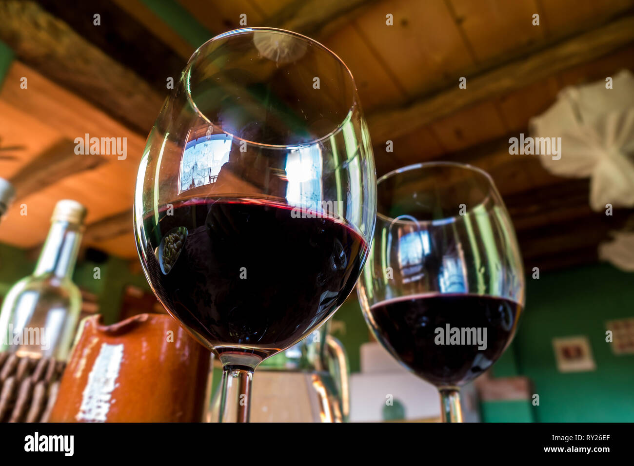 Glass of red wine on a table in rustic restaurant Stock Photo