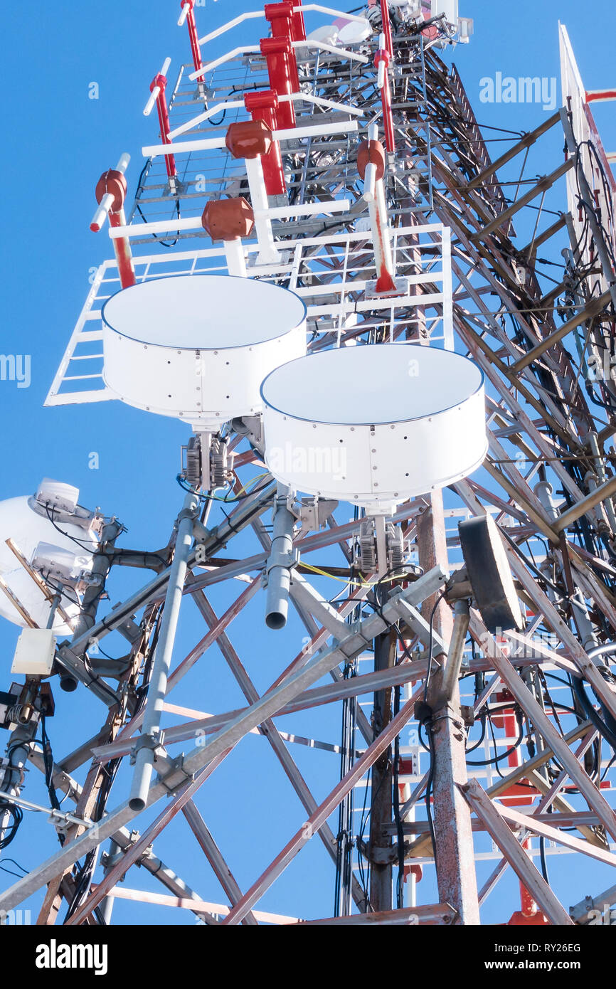 Telecommunication network repeaters, base transceiver station. Tower wireless communication antenna transmitter and repeater. Telecommunication tower  Stock Photo