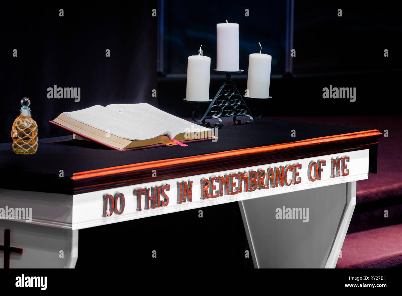 Horizontal shot of a church’s Communion Table With a Bible and Candles on it in a Christian Church. Stock Photo